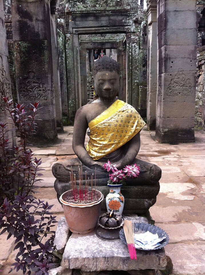 Angkor Wat Buddhist statue with incense sticks setting