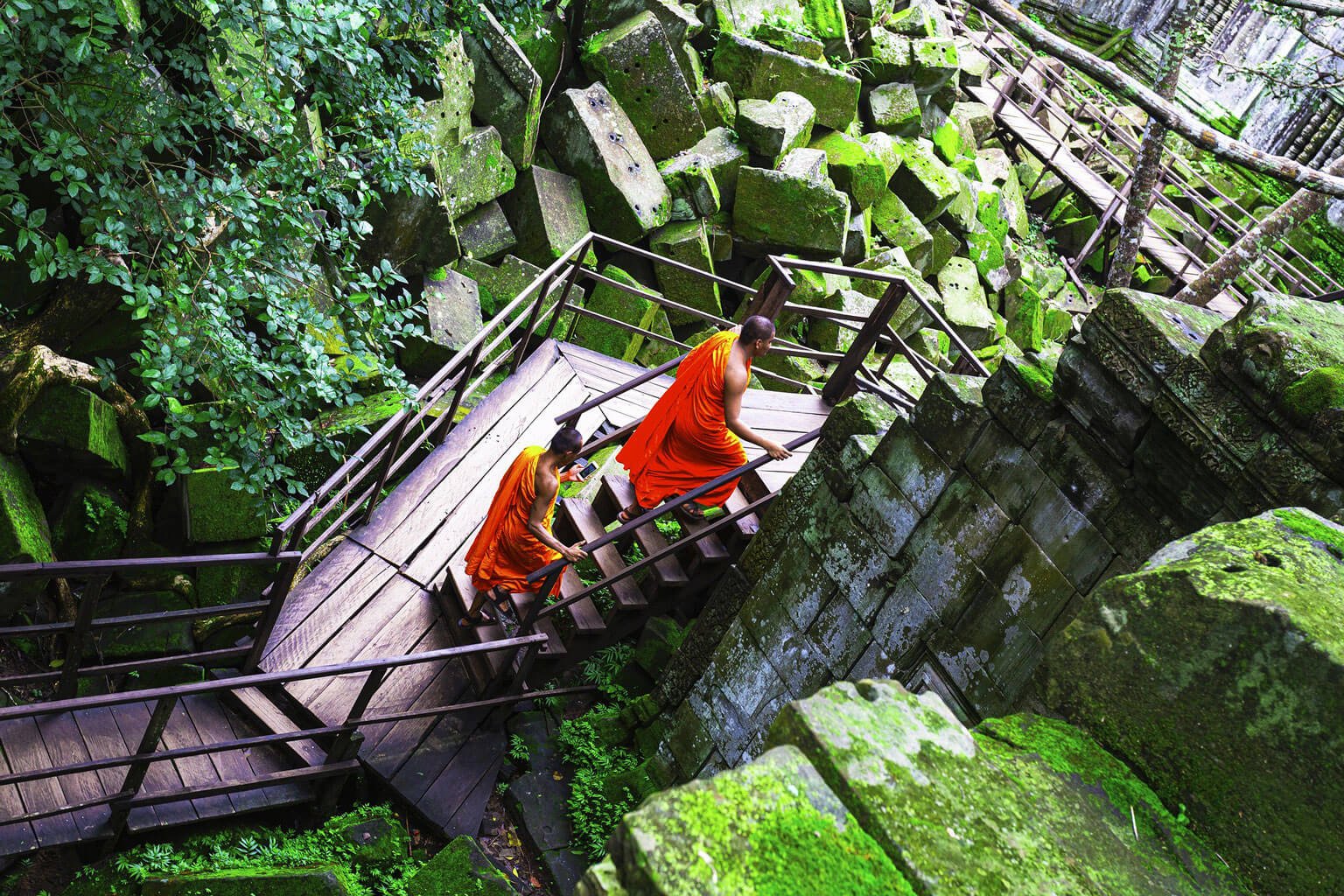 Pair of Buddhist monks walking through a Khmer temple