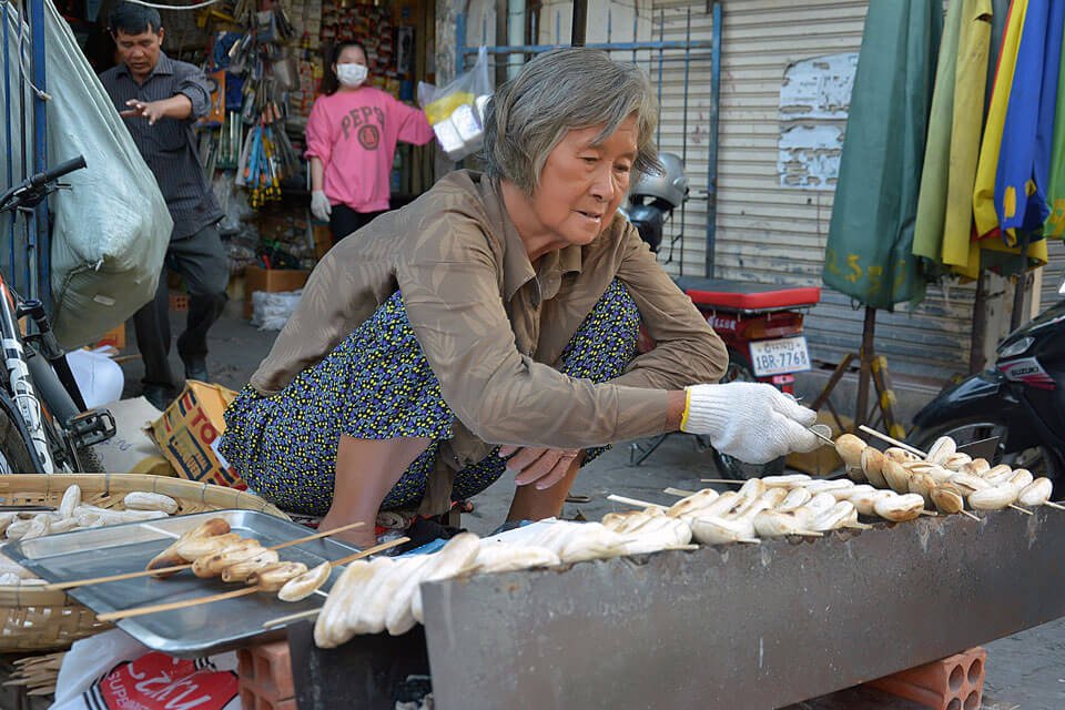 Cambodian street food vendor grilling bananas